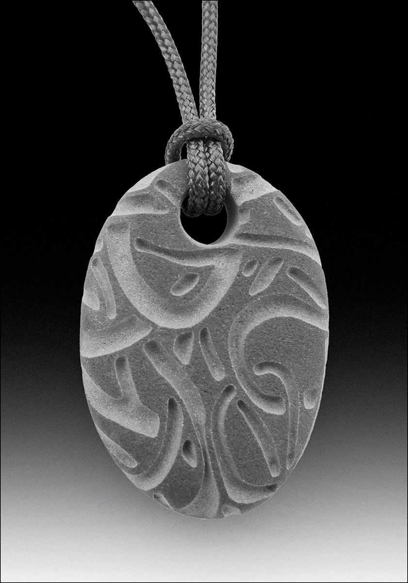 Beach pebble pendants, basalt, each about 2” long. 